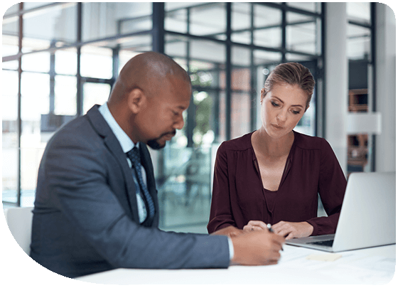 Business professionals discussing documents in a modern office